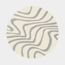 Tapis Belle-Île rond, relief doux et lignes fluides évoquant le sable et la mer