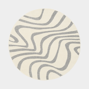 Tapis Belle-Île rond, relief doux et lignes fluides évoquant le sable et la mer