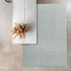 Tapis de salon en relief Circle courbe gris bleuté sous table design béton clair