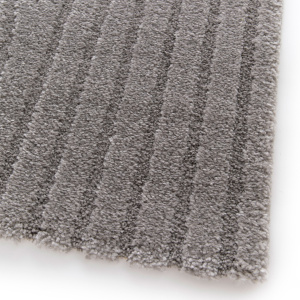 Vue rapprochée du tapis Circle Courbe gris chaud montrant la texture en relief