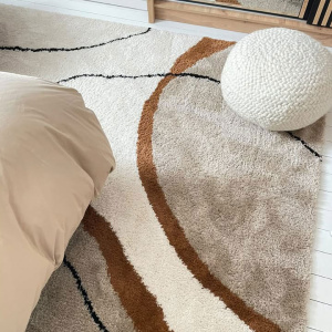 Tapis Courbes du Désert beige et marron, lignes organiques évoquant les dunes dans une décoration intérieure raffinée