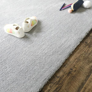 Bordure soignée du tapis salon velours gris perle, finition qualitative et discrète