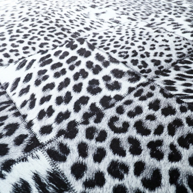 Détail du motif imprimé léopard en patchwork noir et blanc, alternance de textures visuelles animalières