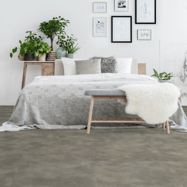 Sol en dalles PVC plombantes effet béton gris clair dans une chambre contemporaine
