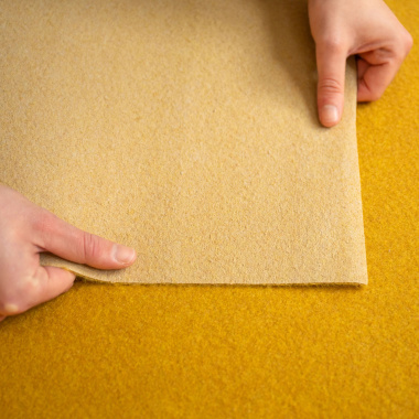 Moquette filmée Stand Event Jaune safran, détail de la sous-face du revêtement pour salons et expositions