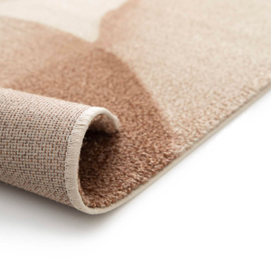 Tapis Élégie Motif aquarelle et tons naturels angle replié montrant structure et qualité de fabrication