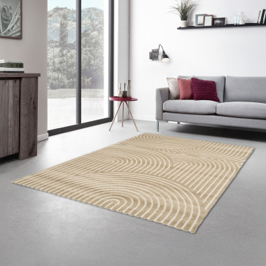 Tapis Circle en relief aux motifs arrondis beige et crème devant un canapé