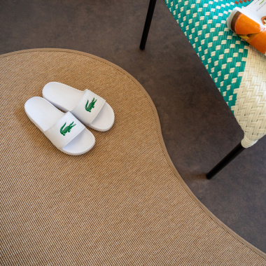 Tapis Mahé Naturel, gros plan sur sa forme organique irrégulière et son style graphique