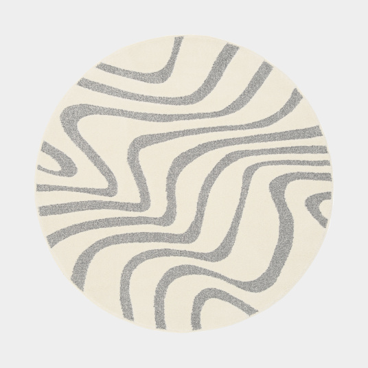 Tapis Belle-Île rond, relief doux et lignes fluides évoquant le sable et la mer