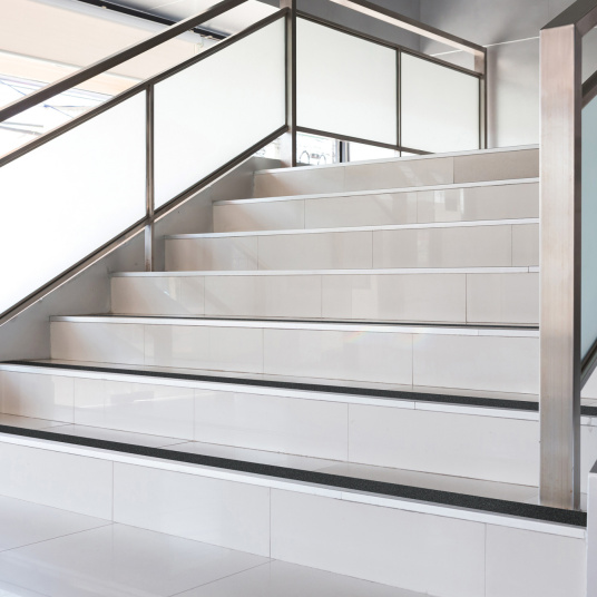 Marches sécurisées avec bandes adhésives antidérapantes noires dans un environnement intérieur