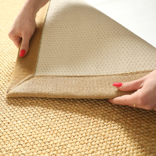 Détail de l’envers du tapis sisal Tulum miel avec la ganse en lin camel 