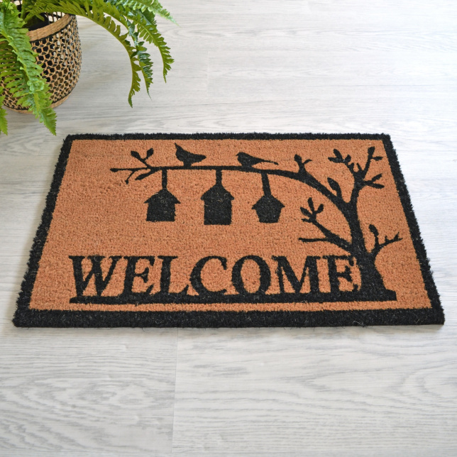 Paillasson coco Oiseaux 71 x 46 cm posé dans une entrée intérieure, fibres naturelles de coco et motif oiseaux noir