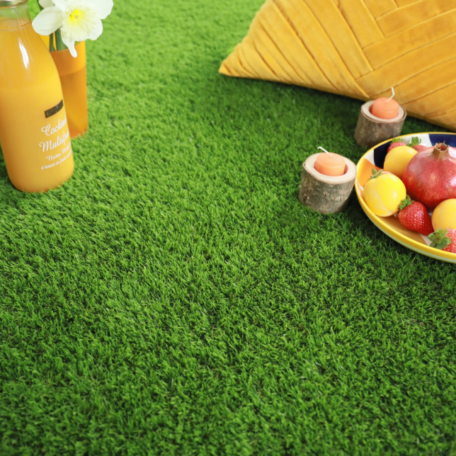 Pause gourmande avec fruits et coussin sur gazon Vitalité 30 mm, ambiance estivale énergisante